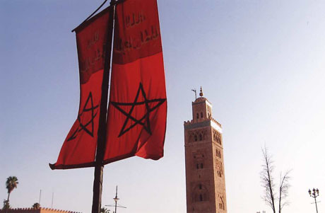 Flag of Morocco and Koutoubia Mosque with its haunting minaret in Marrakesh